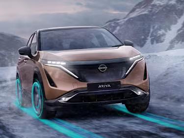 Nissan ARIYA car driving through snowy mountains
