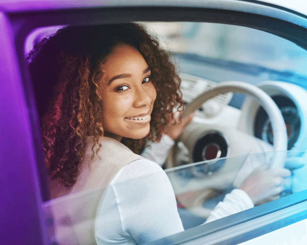 a customer smiling in their car