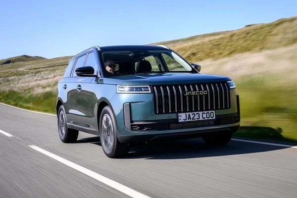 Green JAECOO 5 SUV driving down a country road