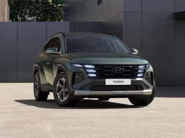 Hyundai TUSCON car in dark green parked in front of a modern building