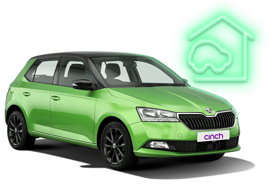 Picture of a green car with a neon sign of a car being delivered to a house.
